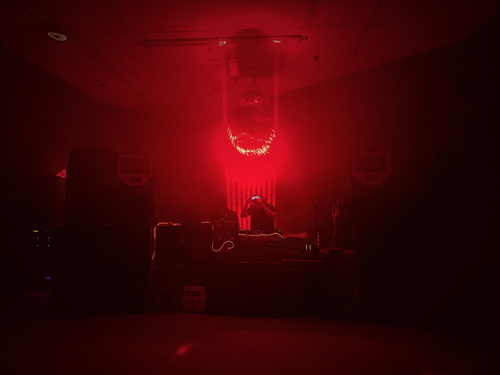 Meed / Syde DJ booth bathed in red haze